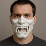3D printed white Oni half-face mask featuring fierce fangs and intricate detailing, worn by a man in a dark shirt.