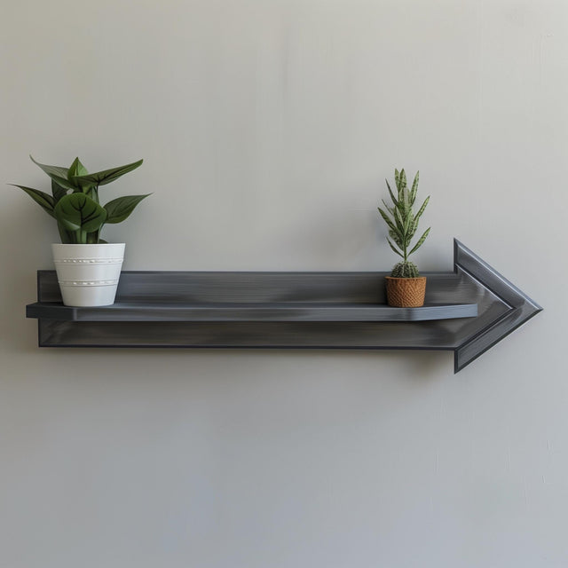 Arrow-shaped 3D printed wall shelf with a geometric ledge and small plants.