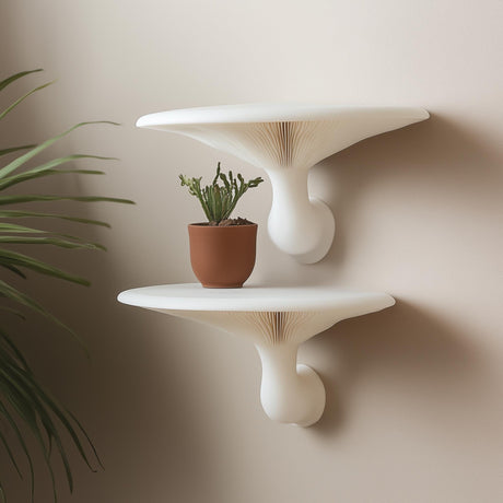 Pair of white 3D printed mushroom-inspired wall shelves mounted on a neutral wall, styled with a terracotta potted cactus.