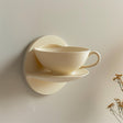 3D printed wall shelf shaped like a teacup and saucer.
