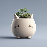 Cute 3D printed matte PLA cat-shaped planter with a rounded body and tiny feet.