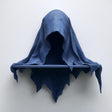 3D printed matte PLA wall shelf shaped like a hooded cloaked wraith with a small straight ledge.