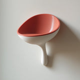 3D printed scoop-shaped wall shelf with a rounded stem support.