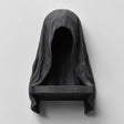 3D printed matte black wall shelf shaped like a hooded cloaked figure with a dark empty face and a small ledge at the bottom.