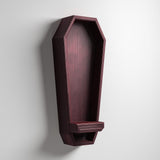 3D printed vertical coffin-shaped wall shelf in dark matte PLA with a small ledge at the bottom.
