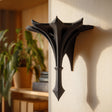 Small gothic-style 3D printed wall shelf bracket with a pointed spire shape.