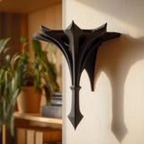 Small gothic-style 3D printed wall shelf bracket with a pointed spire shape.