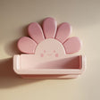 3D printed kawaii flower wall shelf with rounded petals, a smiling face, and a small floating ledge.