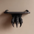 3D printed wall-mounted shelf featuring a dark fantasy monster claw gripping a flat floating ledge.