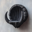 3D printed wall-mounted shelf shaped like a dark fantasy horned crescent.