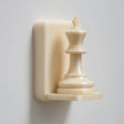 3D printed wall-mounted shelf designed as a chess king piece standing on a compact floating ledge.