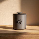 3D printed cylindrical pet cremation urn with a minimalist paw cutout.