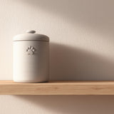 Minimalist 3D printed pet cremation urn with subtle paw print detail.