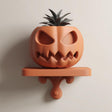 3D printed ribbed character wall shelf displayed with a separate small plant pot.