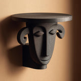 3D printed sculpted face wall shelf supporting a flat circular display top