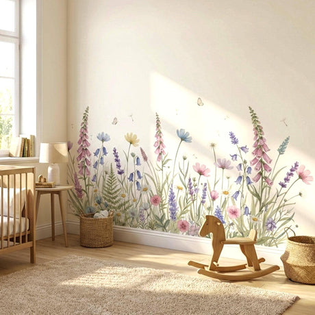 A wide, horizontal watercolor illustration of a wildflower meadow against a white background.
