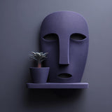 3D printed abstract face wall shelf holding a separate small plant pot