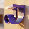 3D printed modern loop wall shelf with rounded support and flat display ledge