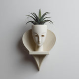 3D printed wall mounted face planter shelf with integrated pot.