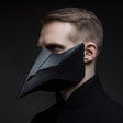 3D printed dark techno raven beak mask worn on an adult model.