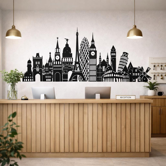 A horizontal black silhouette illustration of various European landmarks on a white background.