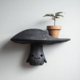 3D printed mushroom character wall shelf with smiling face and broad cap display ledge