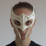 3D printed fantasy sculptural face mask with winged horn tips and elongated fang-like cheek points and open eye cutouts.