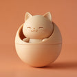 3D printed kawaii cat pet ashes urn with a smiling cat figure nested in a rounded orb container and visible print texture.