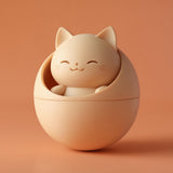 3D printed kawaii cat pet ashes urn with a smiling cat figure nested in a rounded orb container and visible print texture.