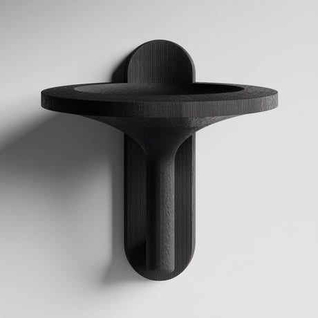 3D printed wall mounted bowl shelf with a wide round tray and sculptural vertical support and visible print texture.