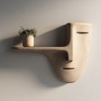 3D printed wall mounted shelf shaped like a minimalist face mask with a long nose-style floating ledge.