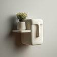 3D printed abstract character face wall shelf with rounded sculptural display ledge