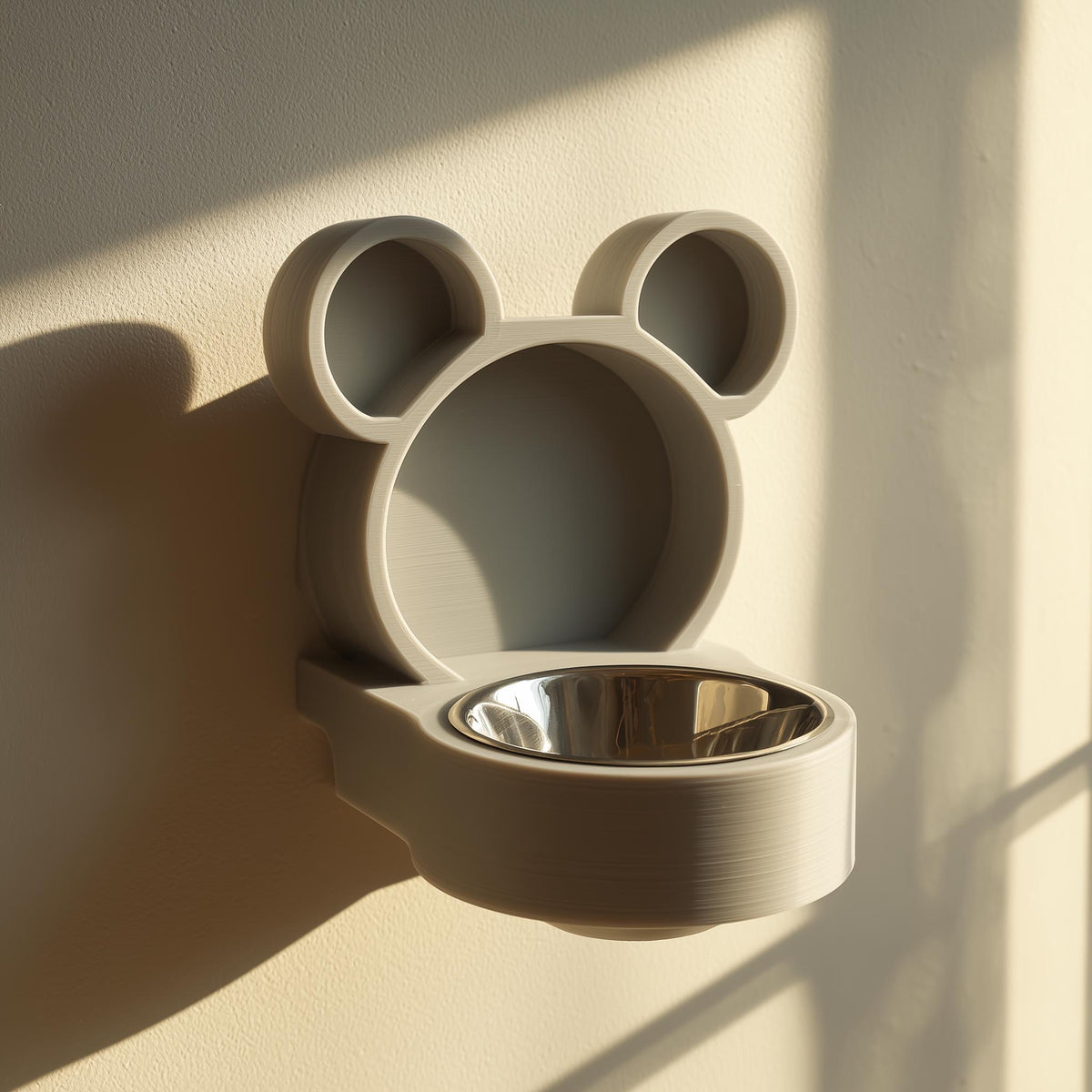 3D printed bear-shaped wall mounted pet bowl holder with round ears and a circular bowl opening.