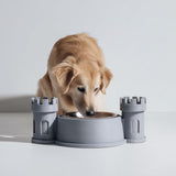 3D printed castle turret pet bowl holder stand with two tower sides and a central bowl opening.