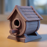 3D printed rustic birdhouse ornament with textured roof and small perch