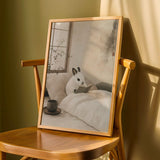 Product detail view of Dwarf Hotot Rabbit Reading in Bed Poster.