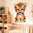 Cute baby tiger cub wall vinyl decal with big eyes and a golden crown, sitting and smiling on a white background.