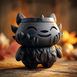 3D printed goblincore creature memorial urn with removable lid displayed on a rustic wooden surface with warm autumn decor.