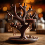 Brown 3D printed antler-style jewelry holder on a wooden surface, with branching antlers and small bowl trays.