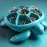 Sea turtle-shaped jewelry organizer with divided shell compartments for rings and small jewelry.