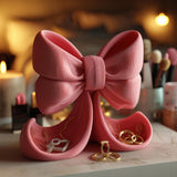 Ribbon-shaped jewelry organizer with curved trays for small accessories.
