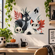Black and cream cats wall decal with a pale ghost, small skull, orange flame and rust-red and muted green foliage.