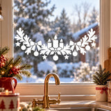 Christmas window decoration with candles, ribbons, fir branches and delicate white hanging baubles