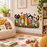 Garden-themed nursery wall decal showing five cats along a colorful fence with blossoms and orange butterflies.