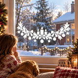Holiday glass decal design with white candles, evergreen bows and suspended Christmas ornaments
