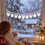 White reindeer Christmas garland design with suspended round ornaments for a kitchen window