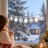 White vinyl snowflake garland for a Christmas window with round baubles along a gently curved string