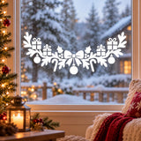 Holiday window sticker featuring a large ribbon bow above gifts, pine sprigs and candy cane shapes