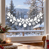 Holiday window decal featuring a large bow with long ribbon tails, stars and festive baubles