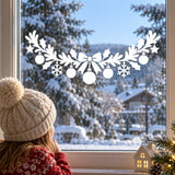 White vinyl window decoration with ribbon bow, snowflakes and suspended star and ball ornaments